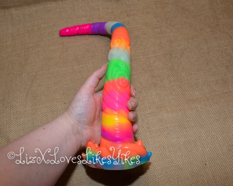 The toy shown in my hand. Review of the Depth Training Unicorn Tentacle Anal Dildo Luminous BigShocked.com Copyright Liz BlackX