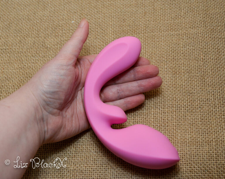 Discover the Magic of Urethral Massage with the Osuga Flow Rabbit Vibrator Copyright Liz BlackX The pink Flow vibrator shown in my hand.