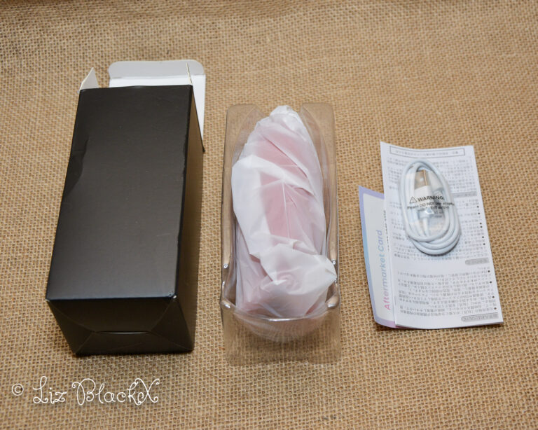 The black box the product came in with, shown with the manual and charging cable. Licking & Sucking Vibrator from Inyarose - A Giggle-Inducing Orgasmic Experience Copyright Liz BlackX